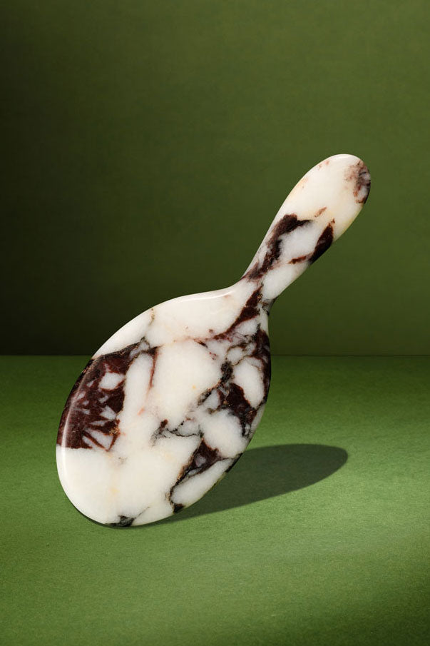 The MRBL Atelier Brush in Calacatta Viola marble, handle up